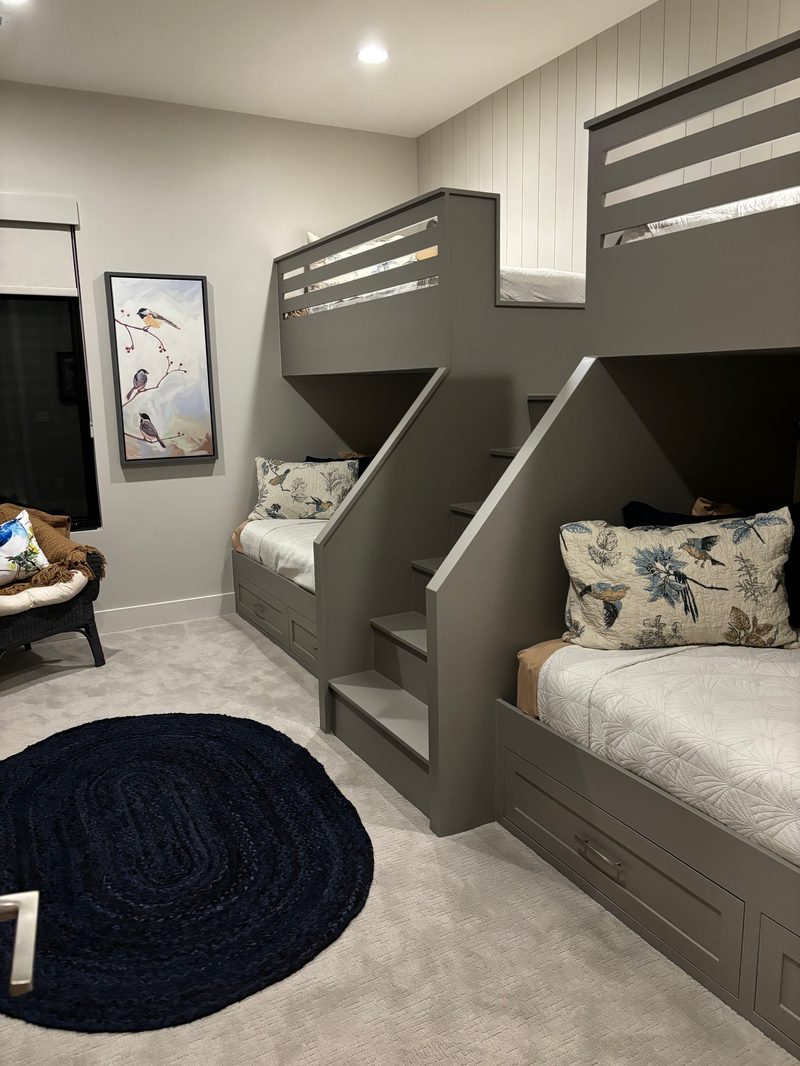 Detail of custom built-in quad bunk beds with integrated staircase and storage
