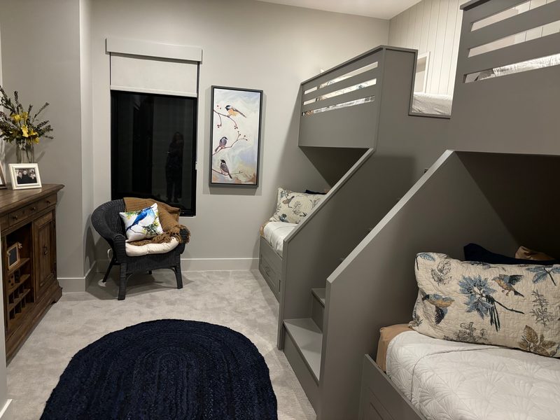 Custom built-in quad bunk beds with integrated staircase in a Utah custom home kids room