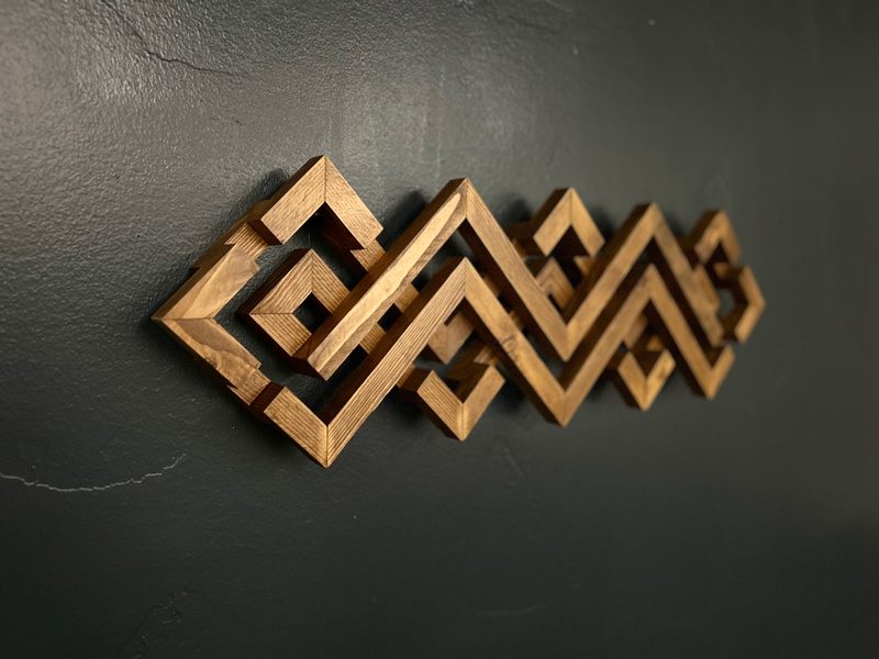 Custom geometric interlocking wood wall sculpture crafted by PrimeWest Construction